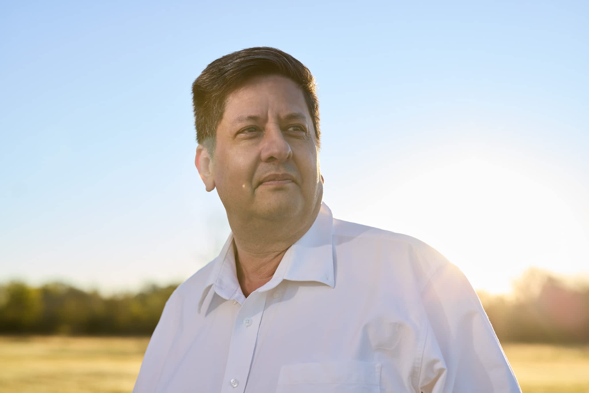 James Bray, Owner of Texas Pride Trailers, looking off-camera outdoors.