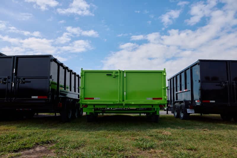 Three large trailers, two black, one green.