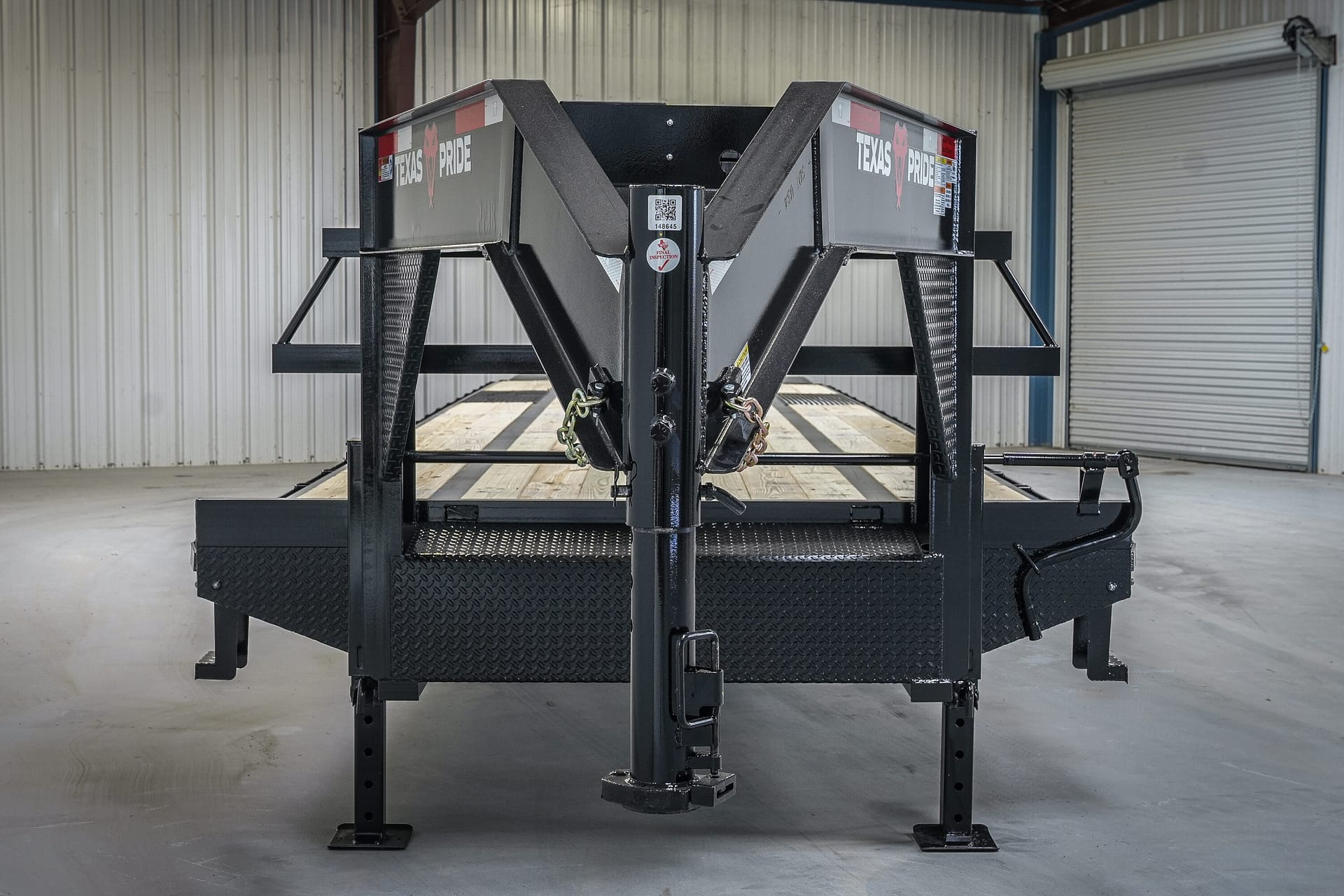 Front view of Texas Pride 40-foot Non-CDL Hotshot gooseneck deck-over flatbed showing dual 12-inch I-beam risers, adjustable 2-5/16 gooseneck ball coupler, and diamond plate gooseneck floor