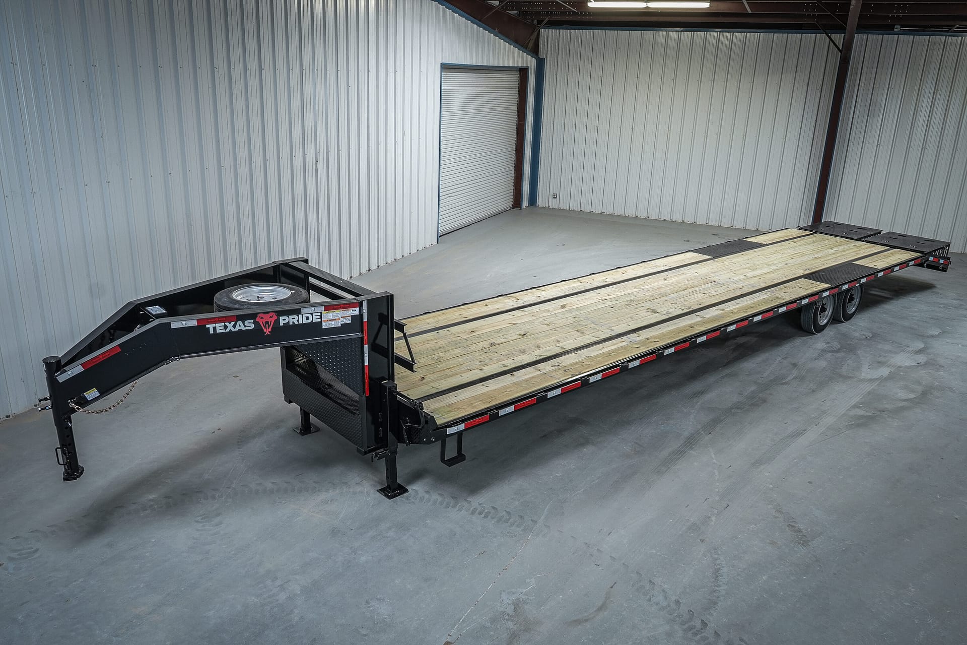 Texas Pride 8.5x40 Non-CDL Hotshot Special deck-over flatbed — 40-foot treated pine deck with stake pockets, recessed LED lighting, and mounted spare tire on gooseneck